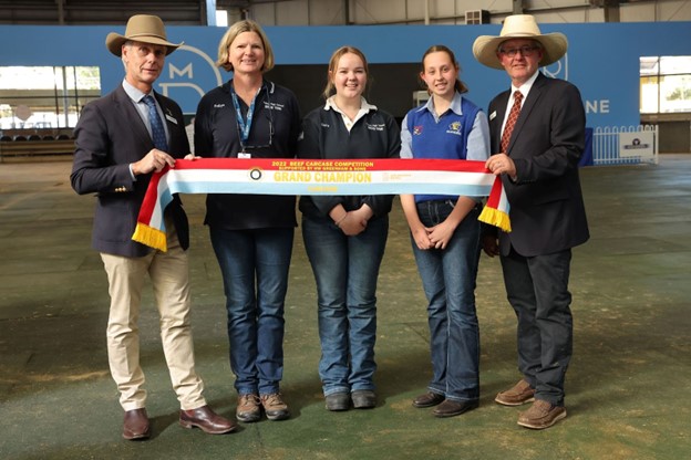 ‘Brad Jenkins, Melbourne Royal CEO, and David Bolton, Beef Cattle Committee Chair, presenting the sash for Grand Champion Carcase to Robyn O’Leary and students from Finley High School’